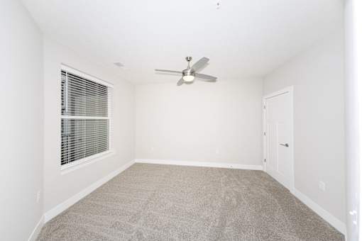 A room with a ceiling fan and carpeted floor.at Tiffany Flats, Columbus, OH, 43231