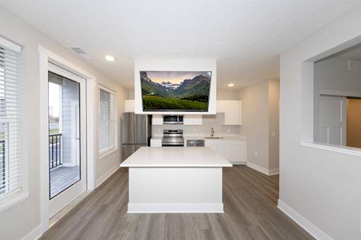 A modern kitchen with a large island and a mountain displayed on the wall.at Tiffany Flats, Columbus, 43231