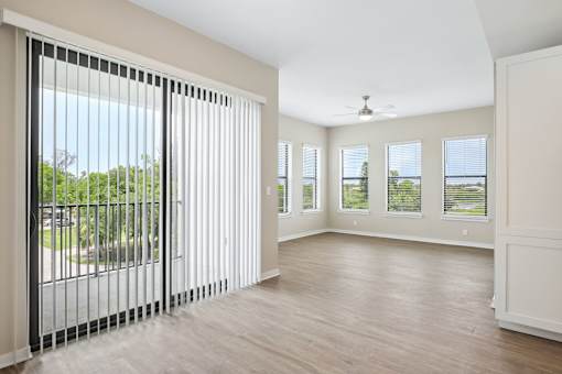 A room with a sliding door and a ceiling fan.