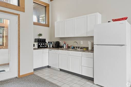 The clubhouse and leasing office at The Woods at McNeil Farms welcomes you! Enjoy amenities like a shared space, pool, and on-site laundry facility.