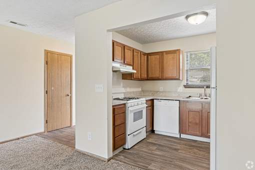 A fully equipped kitchen with appliances like refrigerator, stove, oven, and dishwasher, of an available home for rent at Cabot's Mill near Columbus, OH.
