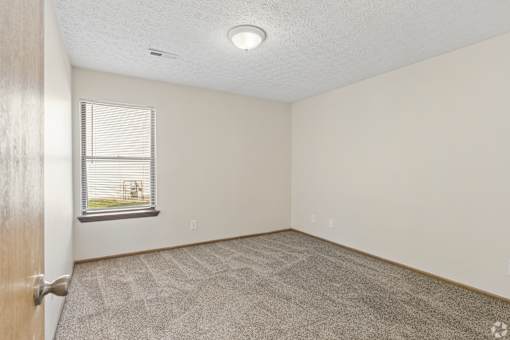 Carpeted bedroom of a home for rent near Columbus.