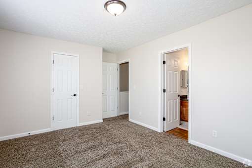 A room with white walls and a carpeted floor.