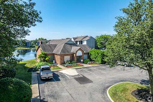 A house with a driveway and a car parked in front.
