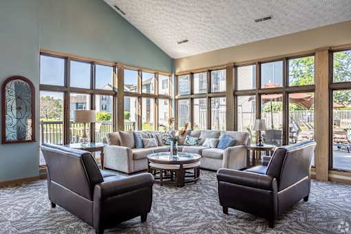A living room with a large window and a view of a backyard.