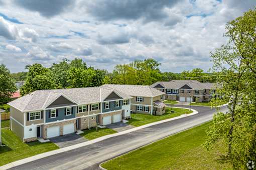 A row of houses with a road in front of them.