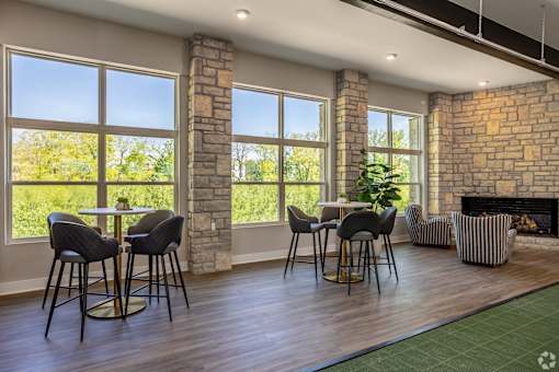 A room with a fireplace and a dining table with chairs.
