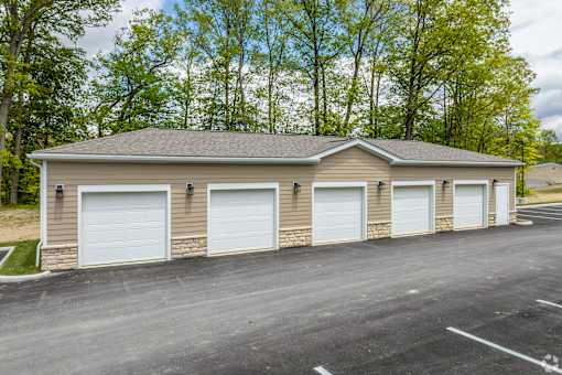 A two-car garage with a brick exterior and white doors.