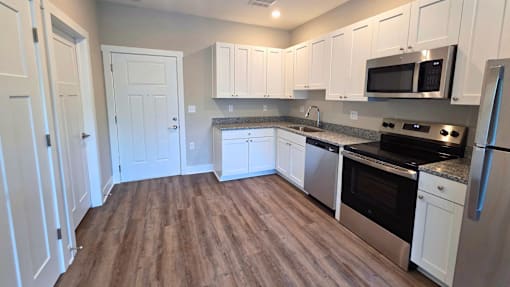Kitchen and living area of an available apartment unit at Greenwood Commons Apartments in Delaware, OH.