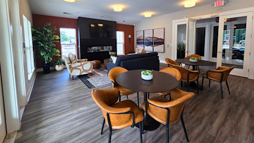 Clubhouse lounge area with seating, television, and fireplace at Greenwood Commons in Delaware, OH.