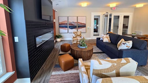 Clubhouse lounge area with seating, television, and fireplace at Greenwood Commons in Delaware, OH.