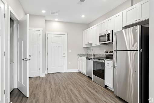 A kitchen with white cabinets and stainless steel appliances.