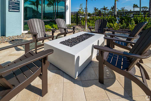 A patio with a fire pit and chairs.at Imperial Crossing Luxury Apartment Homes, Bonita Springs, FL, 34134