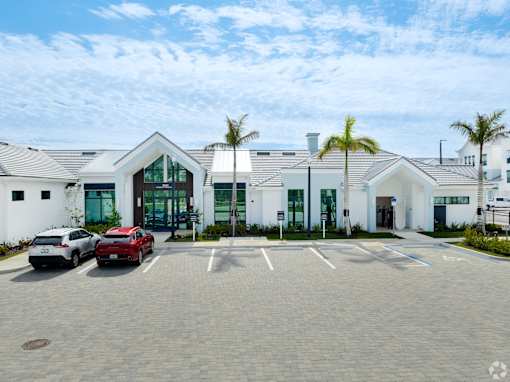 A parking lot with cars and a building in the background.at Imperial Crossing Luxury Apartment Homes, Florida