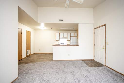 A room with a white counter and a fan on the ceiling.
