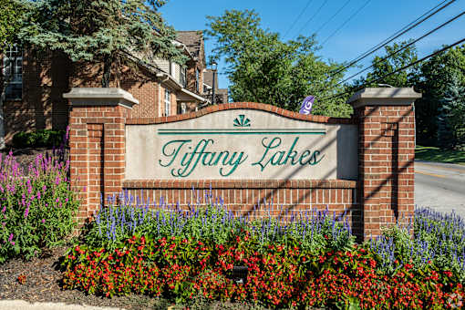 A sign that says Tiffany Lakes in front of a house.