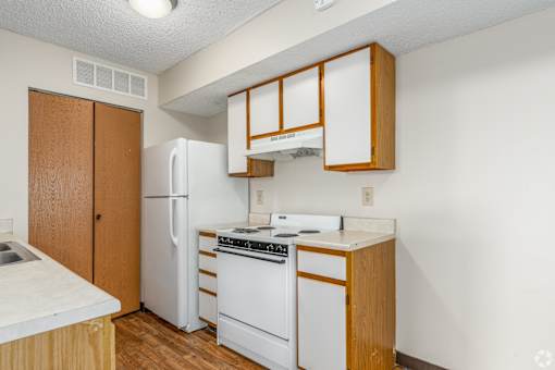 Kitchen of a River Valley apartment home in Lancaster, OH, with cabinets, stove, oven, refrigerator.