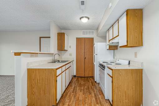 Kitchen of a River Valley apartment home in Lancaster, OH, with cabinets, stove, oven, refrigerator.