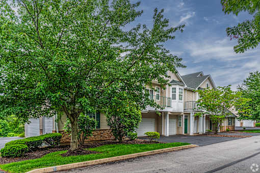 A tree in front of a house.