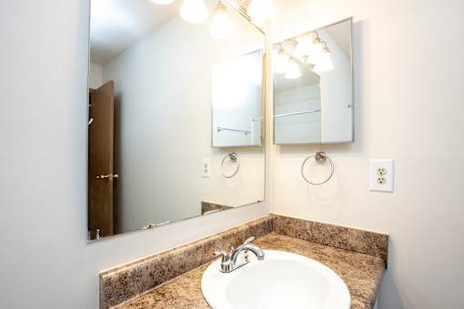 A bathroom with a sink and mirror.