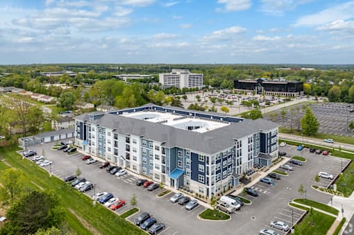 A large building with a parking lot in front of it.