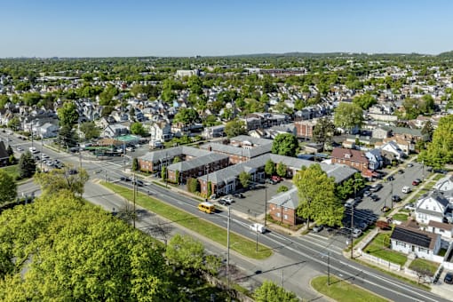 A small town with a lot of greenery and a clear sky.