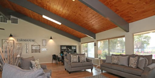 a living room with couches and chairs and a large window