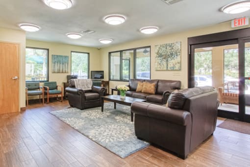 lobby with large windows, ample comfortable seating, and overhead lighting
