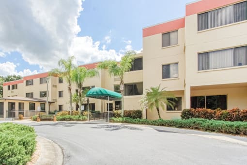 circular drive with covered entrance to Villa San Carlos Senior Apartments