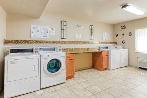 laundry center with washers and dryers and folding area