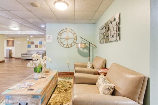 couch, chair, and coffee table in sitting area by elevator