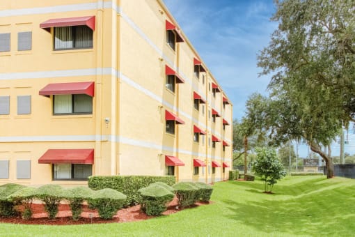 Casa San Pablo senior apartments exterior with mature trees and trim grass