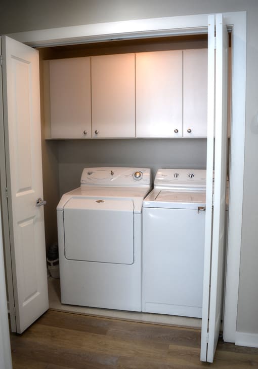 Side-by side white washer and dryer at Residences at Forest Park, Missouri