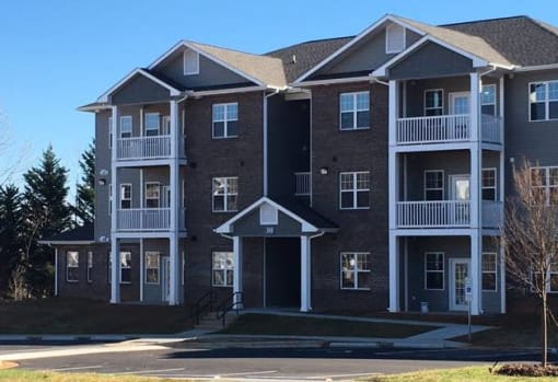 A large apartment building with a balcony on the second floor.