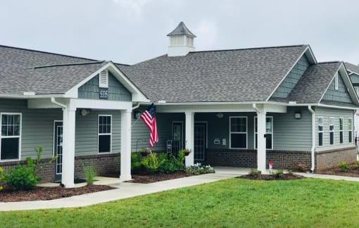 A building with a grey roof and a flag on the front.