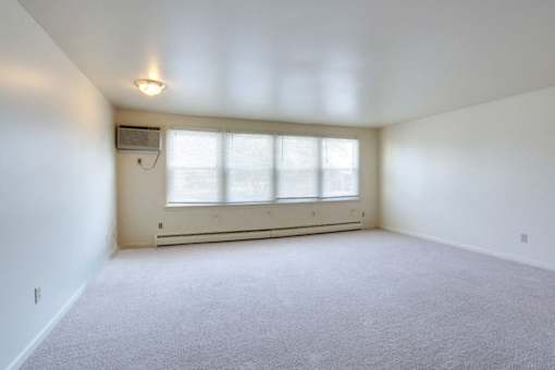 Berkley Manor Apartments - Living Room – Air Conditioning Unit – Natural Lighting - Ask for a Tour - Pet Friendly