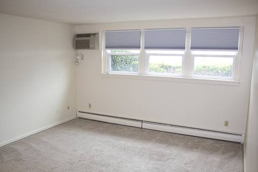 Berkley Manor Apartments - Living Room – Air Conditioning Unit – Natural Lighting - Ask for a Tour - Pet Friendly