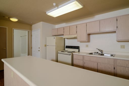 Kitchen with serving island at Cameron Park Village Apartments, Cameron Park