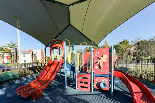 covered playground at East Village Apartments in Davie, FL