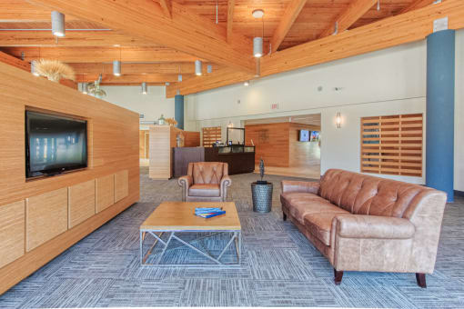 Couch, coffee table, and TV in lobby at St. Giles Manor