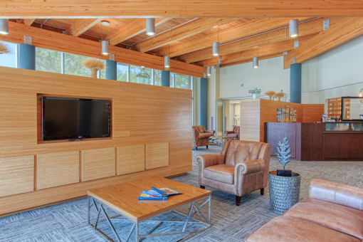 TV, couch, sitting area, and reception desk in lobby