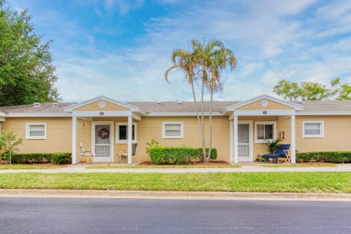 well-kept villas with shrubs and palm trees