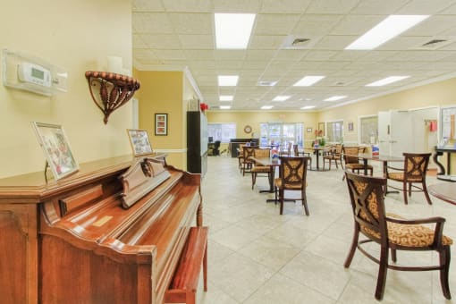 Piano in community room with ample seating