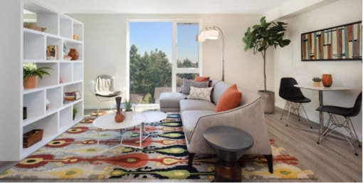 Living Room with white bookshelf, plank flooring, and large floor-to-ceiling windows at Arabella Apartment Homes, Shoreline, WA, 98155