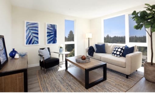 Living Room with plank flooring, spacious living room rug, and large floor-to-ceiling living room windows at Arabella Apartment Homes, Shoreline, 98155