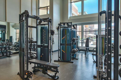 indoor gym with free weights, benches, and cable machines at The Apex at CityPlace, Overland Park
