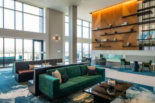 large atrium with long couches placed around coffee tables and large windows at The Apex at CityPlace, Overland Park, 66210