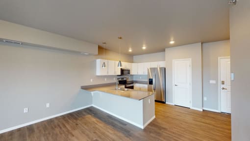 Kitchen With Modern Lighting at Upscale Living at the Grand off 45th, Fargo