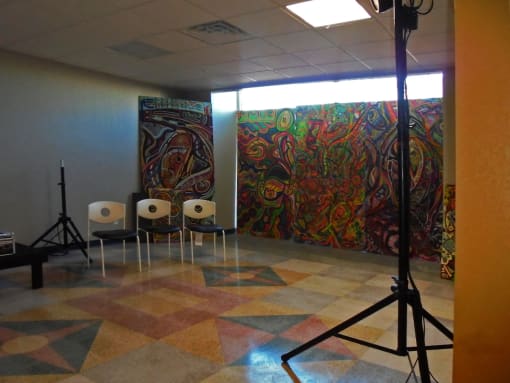mural in room with studio lighting and chairs for seating