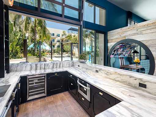 Clubroom with bar and lounge area at Vida North Park, San Diego